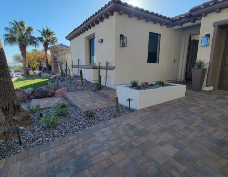A patio with a planter and a fire pit.