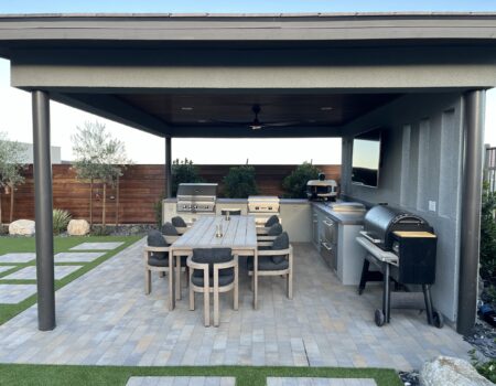 A patio with an outdoor grill and table