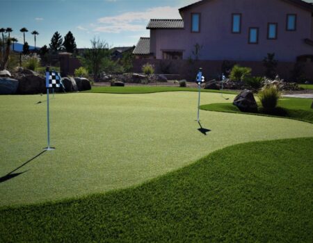 A golf course with a green and some flags